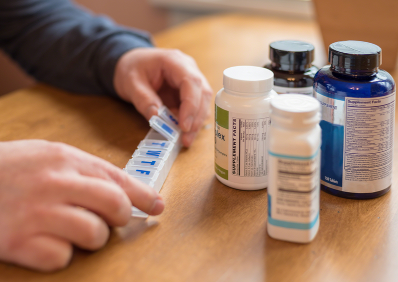 A caregiver managing medication for a senior.