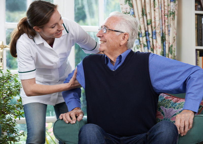 A female nurse assisting patient at an assisted living facility