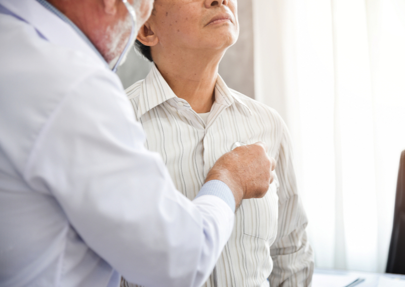 A doctor checks a senior for pneumonia