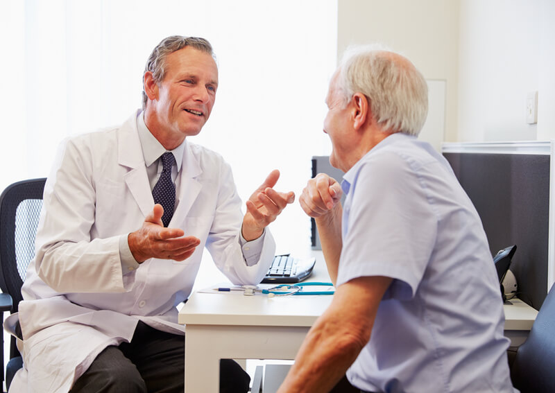 A doctor speaking to a senior