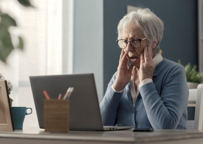 Cyber-Security-For-Seniors:-Tips For-Protecting-Yourself-Online senior looking at her laptop
