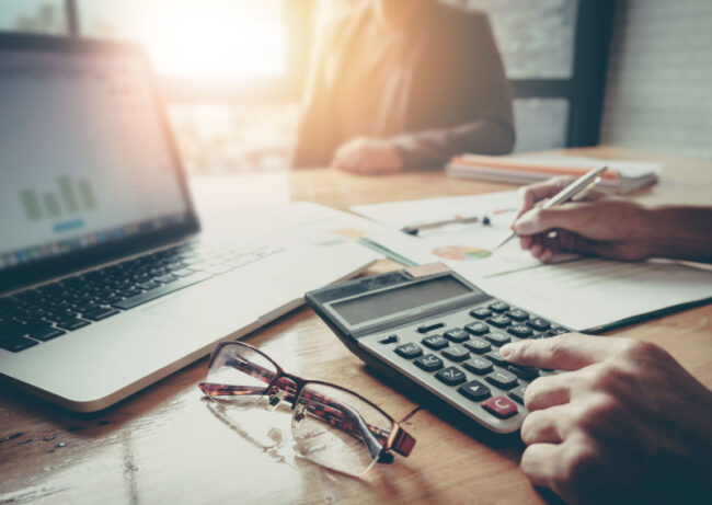 How-To-Finance-For-Assisted-Living:-A-Guide-To-Seniors Individual calculating the cost of assisted living.