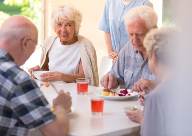 assisted-living-senior-sugar-substitutes A senior enjoying a sugar substitute at an assisted living home.