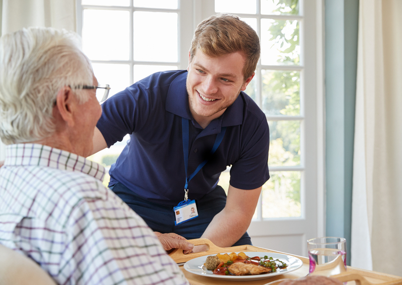 A nurse and a resident in an assisted living home.