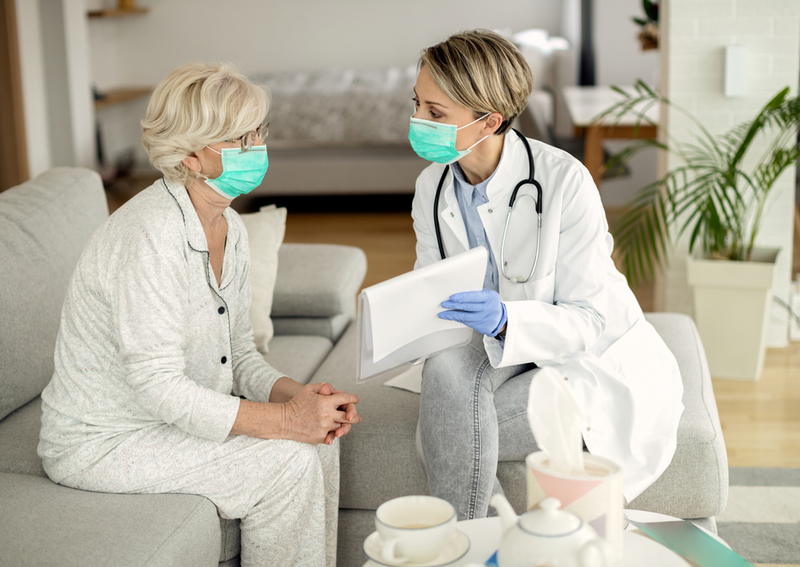 A caregiver at an assisted living center discusses with a resident.