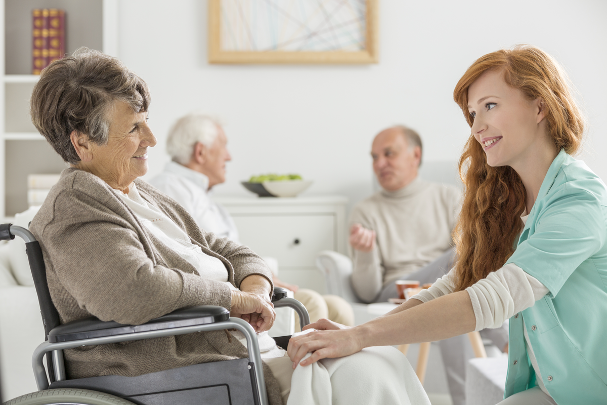 A senior and staff member at an assisted living facility.