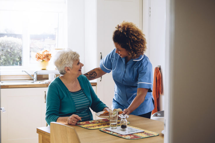 meals-in-assisted-living A senior is given a meal in an assisted living facility.