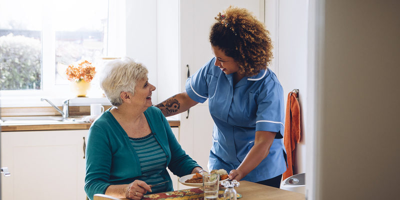 meals-in-assisted-living A senior is given a meal in an assisted living facility.