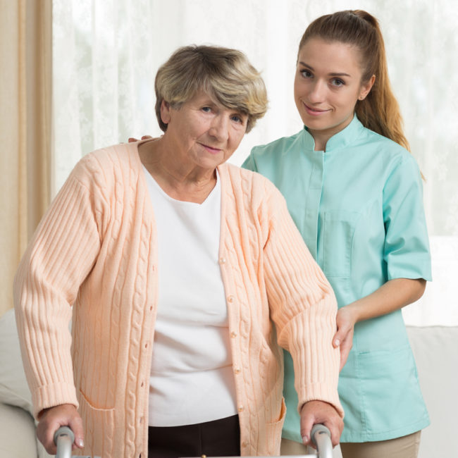 recuperative-care-senior-routine A nurse and a senior in a skilled nursing home.