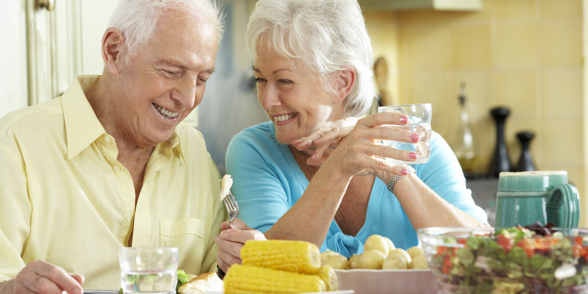 A senior couple living happily in an assisted living facility.