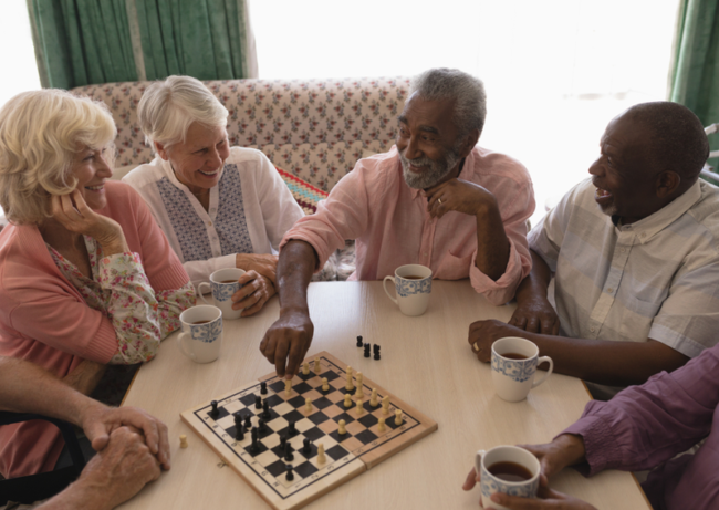 Activities-Of-Daily-Living-In-Senior-Living assisted living group playing chess