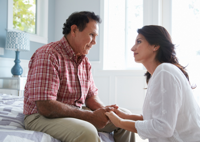 How To Start Conversations With The Elderly?  Adult daughter speaking with elderly father about assisted living
